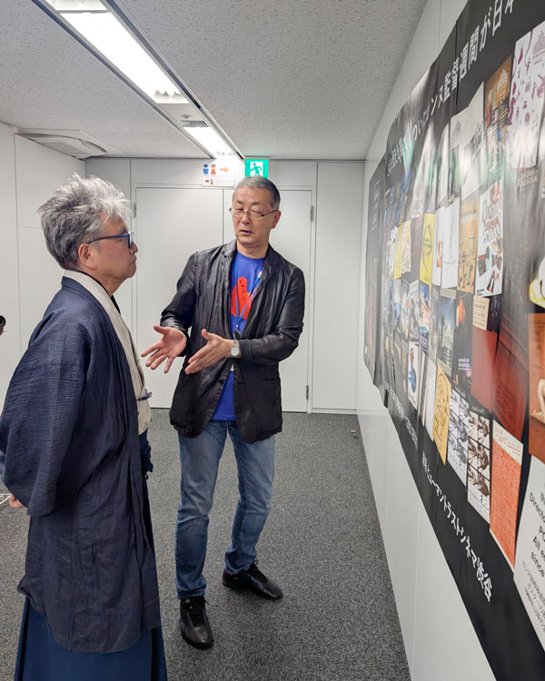 カンヌ監督週間in Tokioのポスターを見る中村氏と市井